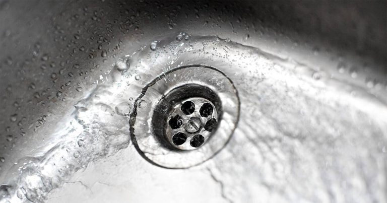 Swirl of water going down the clogged sink